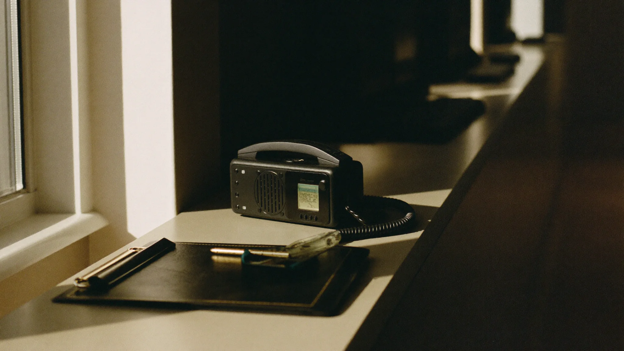 A radio and clipboard on a windowsill, a municipal operations post.