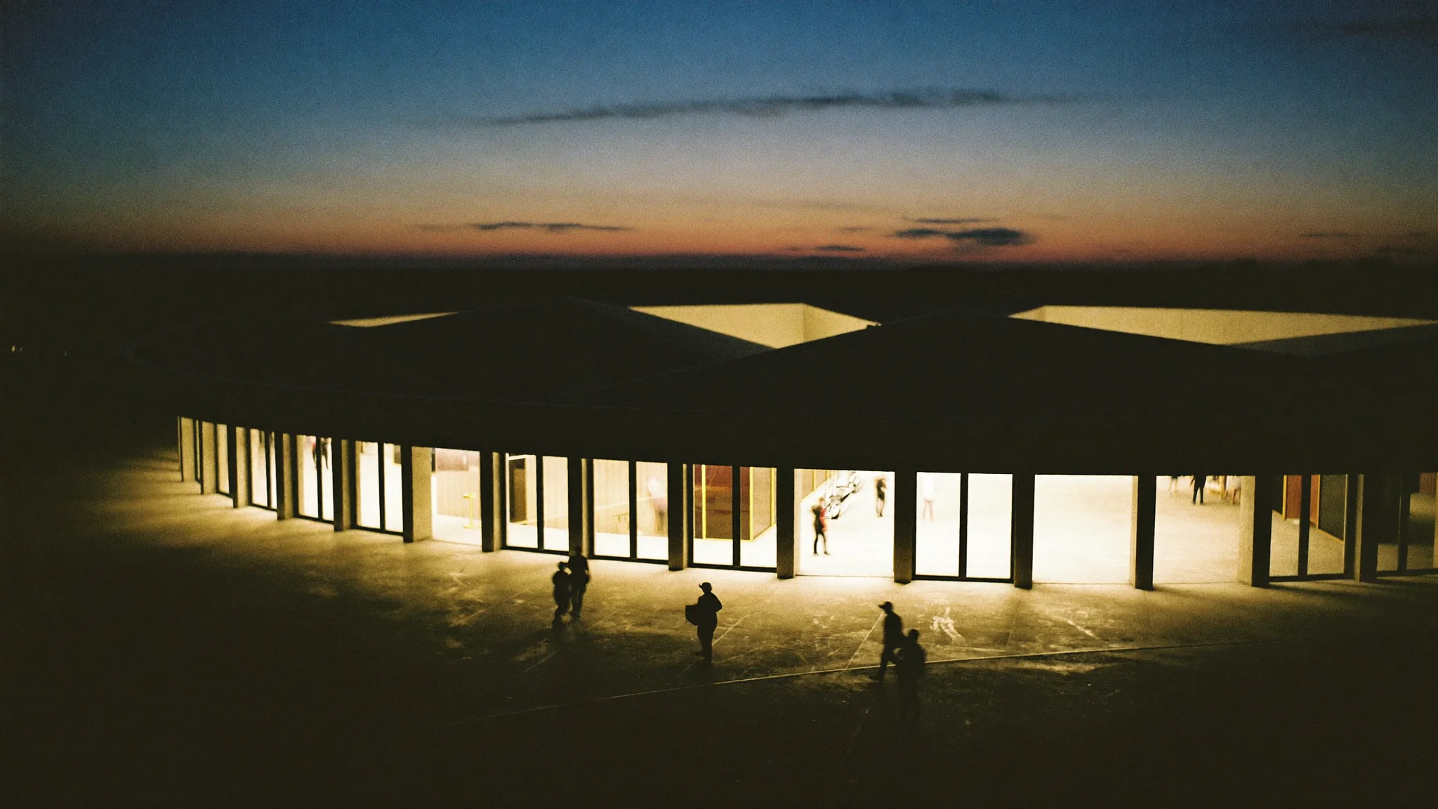 An event plaza lit at dusk.